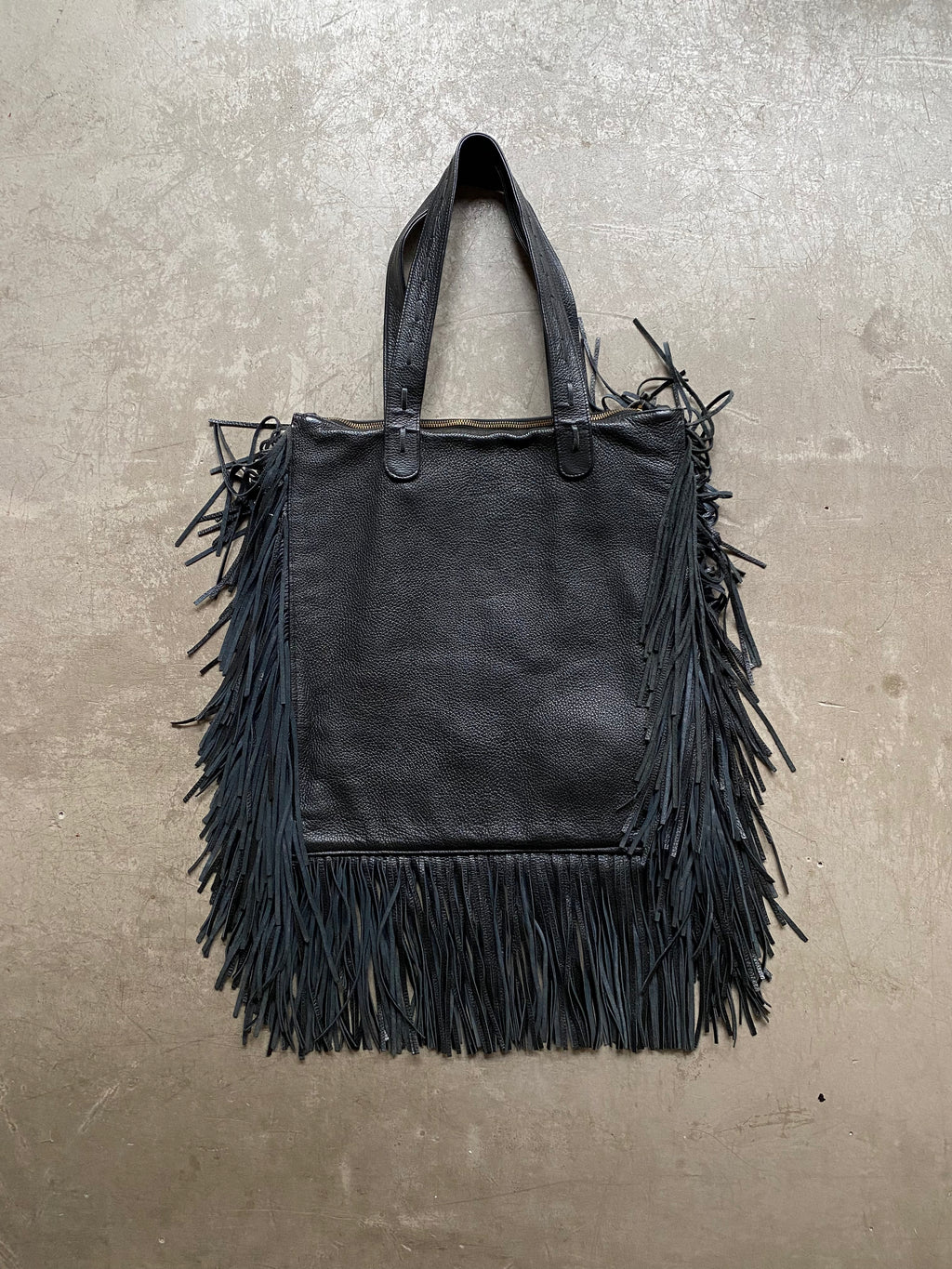 Black leather handbag with fringe