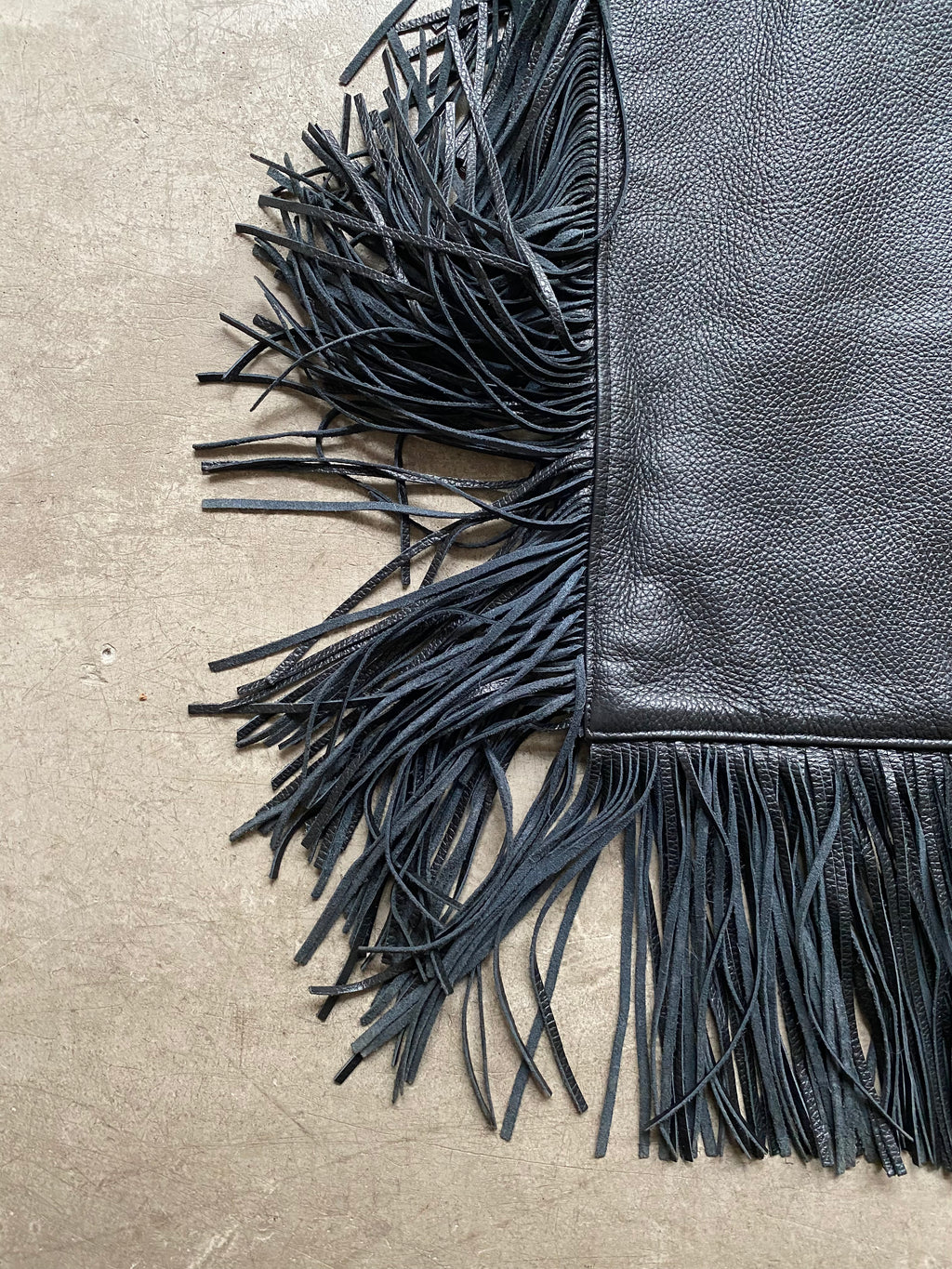 Black leather handbag with fringe