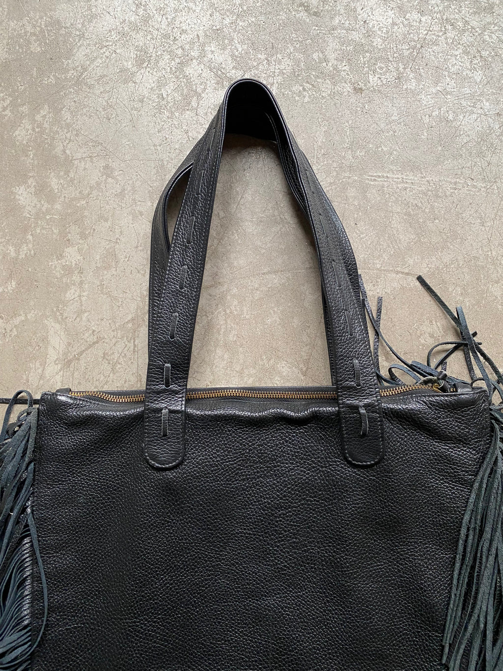 Black leather handbag with fringe