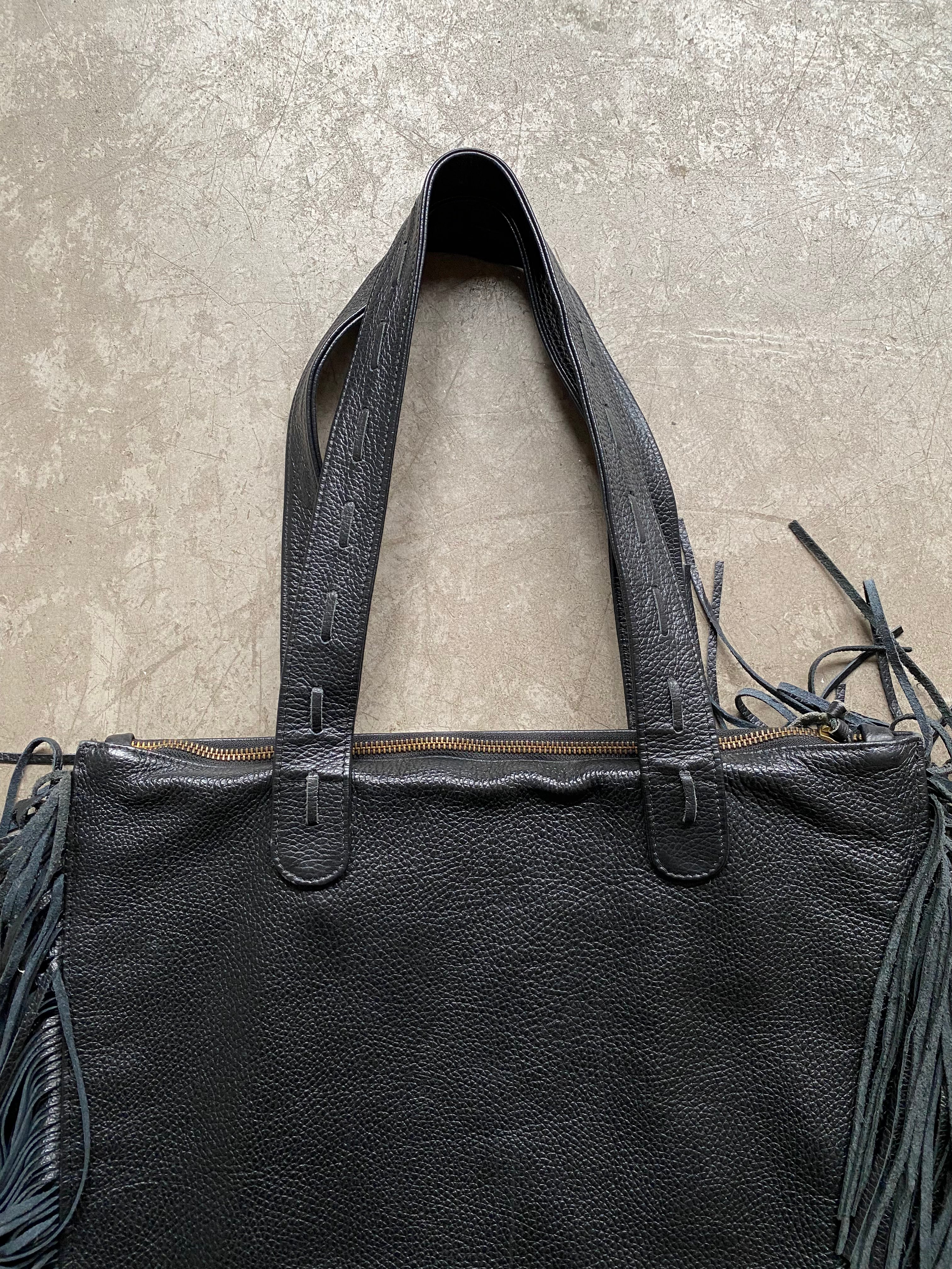 Black leather handbag with fringe